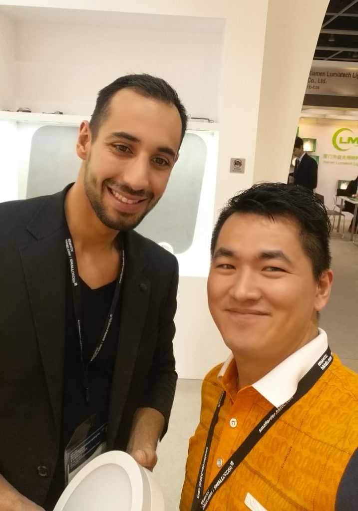 ISHA Lighting team meeting with a European client at a lighting exhibition to discuss LED downlight solutions