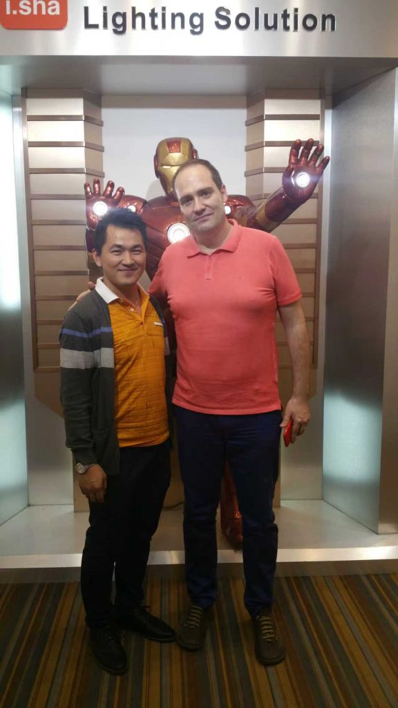 ISHA Lighting team meeting with a UK client at a lighting exhibition to discuss LED lighting solutions